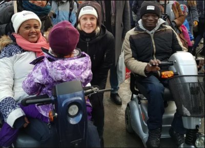 3 smiling people demonstrating