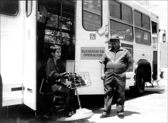 © photo of a woman descending a lift-equipped bus in Mexico City