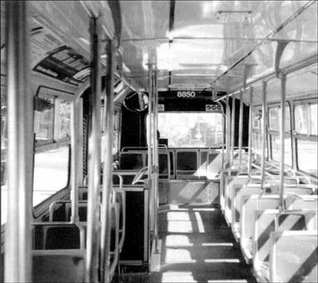 © photo of a bus interior, cluttered with grab posts
