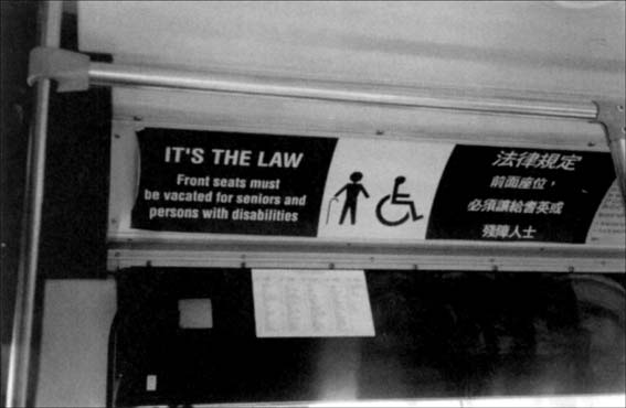 © photo on a bus of a reserved seating sign for elders and those with disabilities