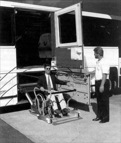 © photo of a man using a lift-equipped bus