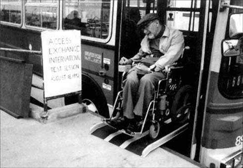 © Photo of a man testing a ramped platform for buses in the USA